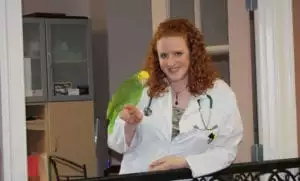 Leslie Pence DVM with a parakeet
