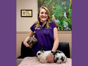 Female with tortoise and white rabbit with black spots